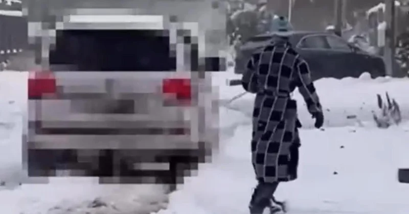 Павлодарец в халате привязался веревкой к машине и катался на сноуборде (видео)